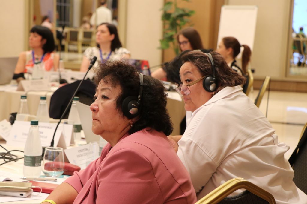 Workshop participants wearing interpretation headsets during a regional meeting