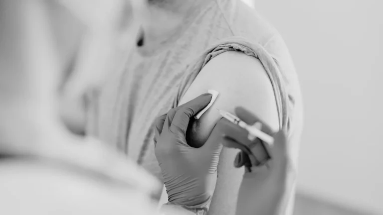 person receiving vaccination from healthcare professional