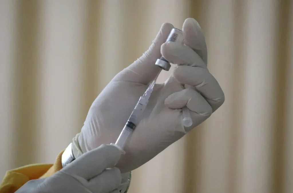 medical professional holds vaccine